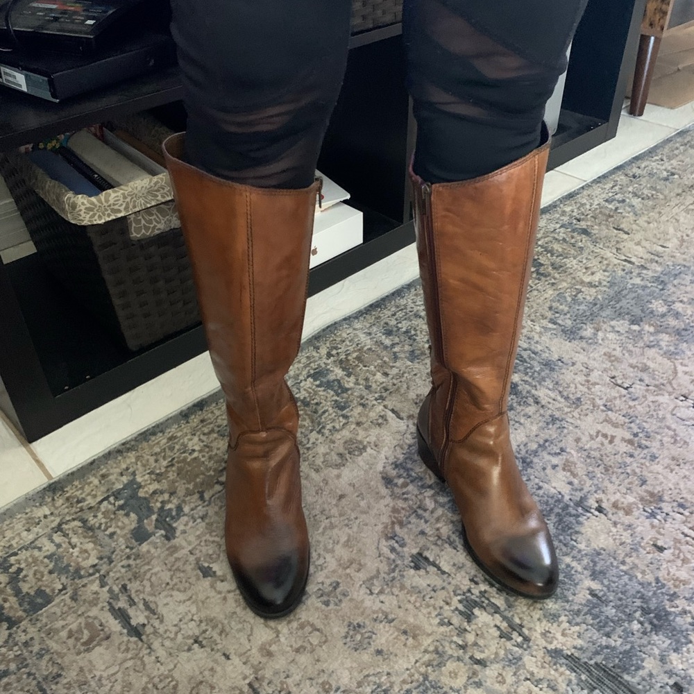 Leather brown mid calf length boots.